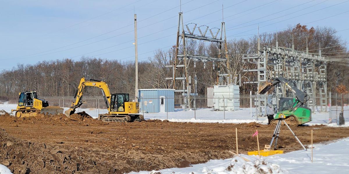 Excavators moving dirt at substation