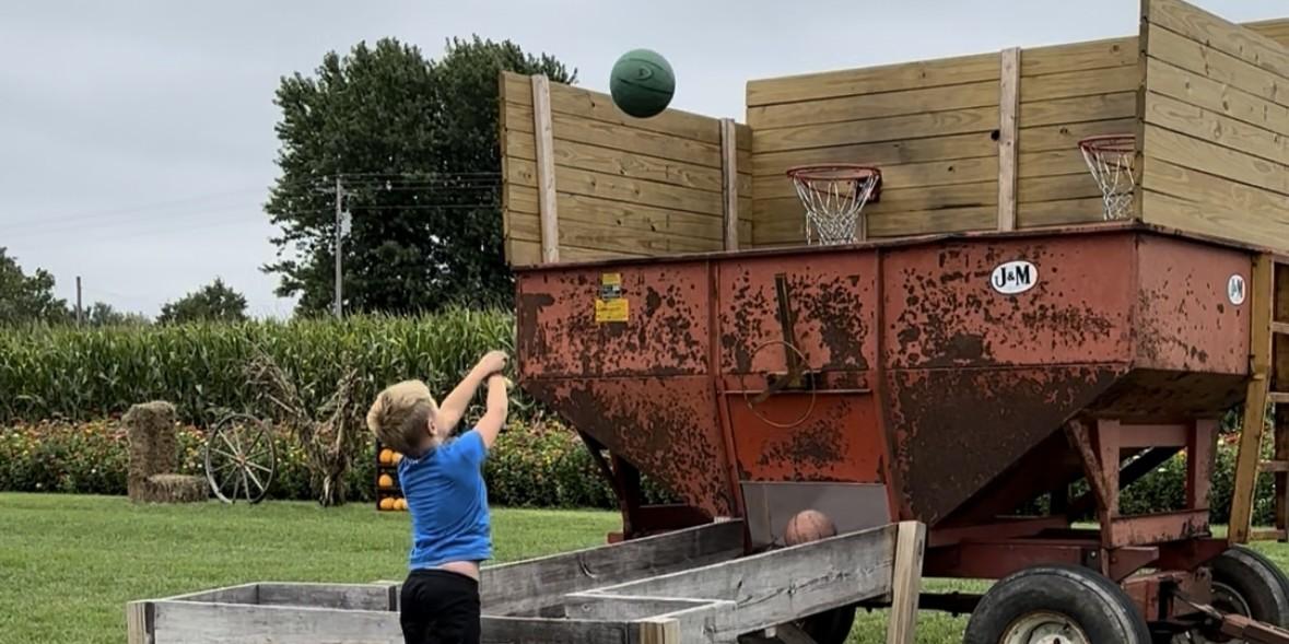 Child takes shot at grain bin basketball