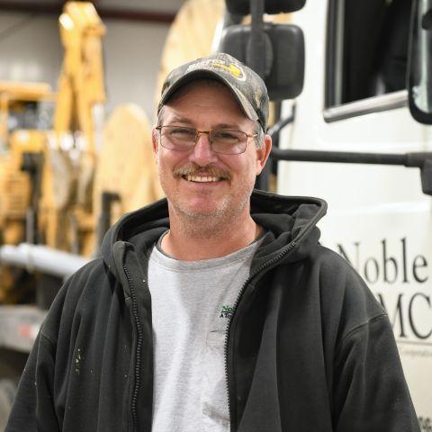 Rob Coil standing in front of truck