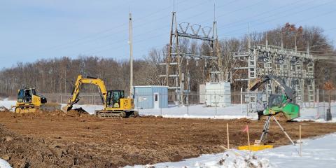Excavators moving dirt at substation