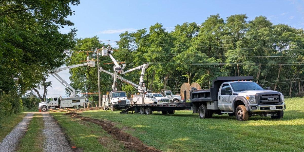 Noble REMC trucks installing line at West Noble