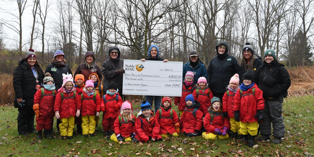 Merry Lea students accepting check
