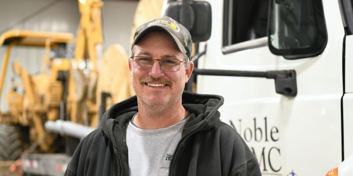 Rob Coil standing in front of truck